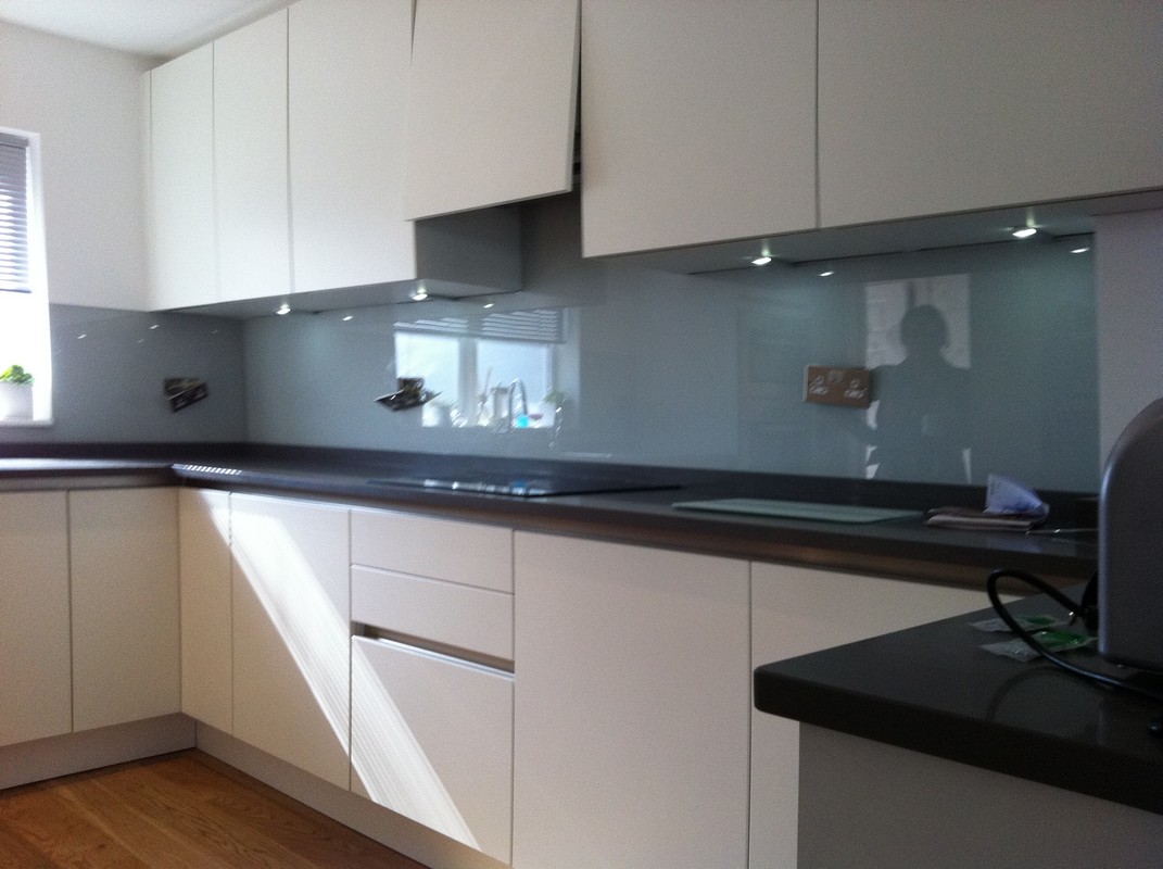 Grey glass kitchen splashback with LED lighting in Greenford